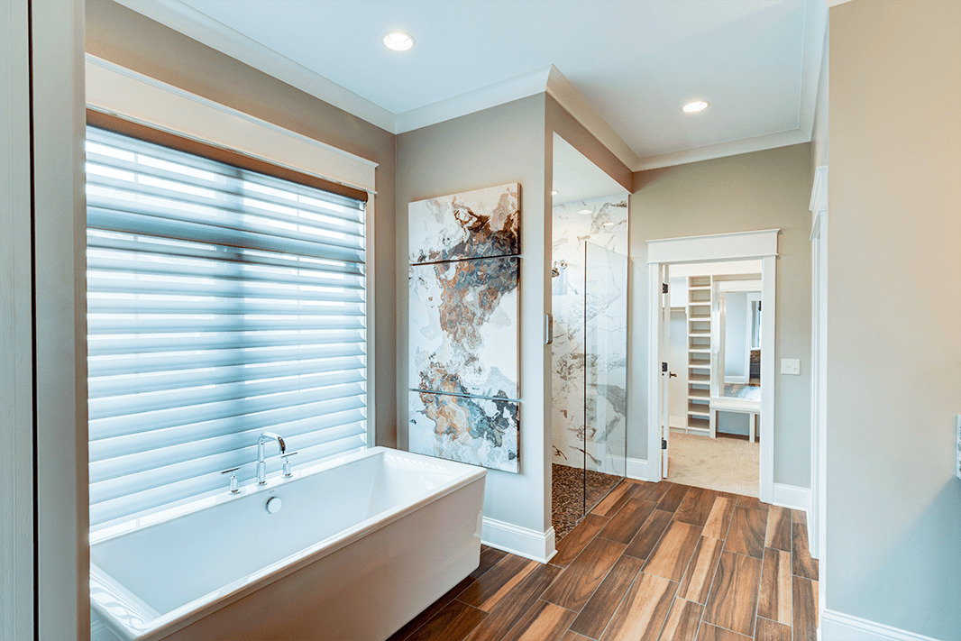 Magnolia Carmel Penthouse Bathroom with White tub and Glass Shower